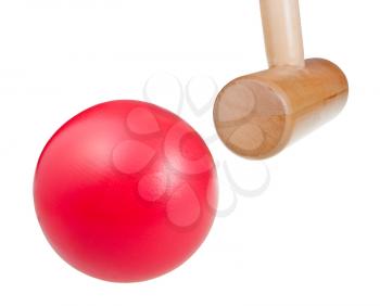 croquet wooden mallet hits red ball close up isolated on white background