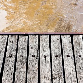 wooden footbridge over slushy rural road