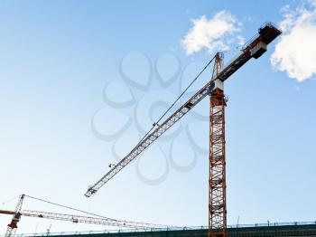 construction crane under blue sky in summer evening