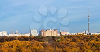 Moscow panoramic view with TV tower, houses and autumn trees and blue afternoon sky
