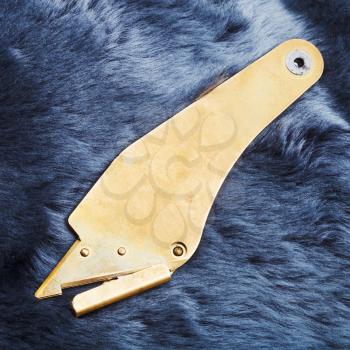 fur knife on blue painted sheepskin