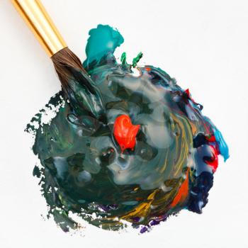 paintbrush blends multicolored watercolors paints and red gouache drop close up