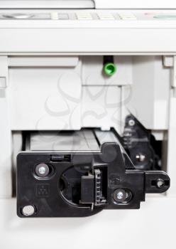 insert of toner cartridge in office copier close up