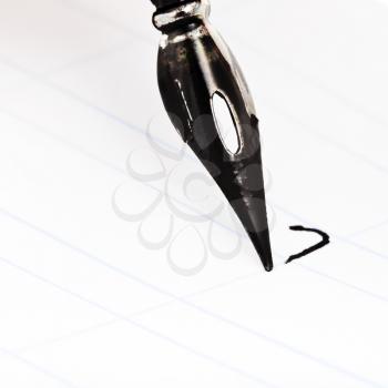 dot the I with metal nib of drawing pen by black ink close up
