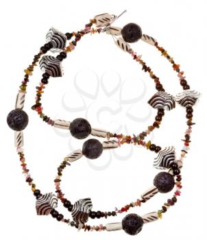 top view of necklace from beads of black rock lava, carved bone, natural mineral stones, carved metal isolated on white background