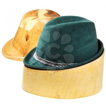 green felt hat on linden wooden hat block and additional hat block isolated on white background