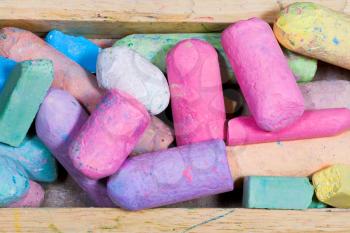 used colored chalks in wood box close up