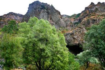 mountain cave of ancient Geghard monastery in Armenia in rain