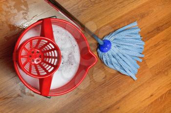 top view of mop and bucket with water for washing floors