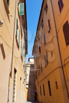 side street in medieval town of Bologna, Italy in sunny day