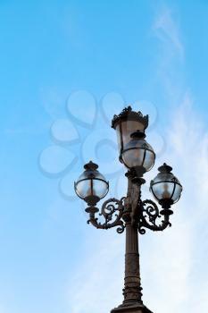 old urban lantern and blue autumn sky in Bologna, Italy