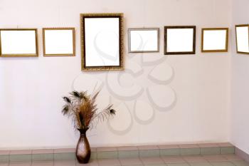 floor flower bowl and several picture frames on art gallery wall