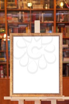 simple picture frame on easel with clipping path and home library on background