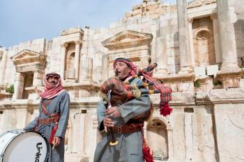 JERASH, JORDAN - FEBRUARY,18: bedouins play on bagpipes in ancient Gerasa, Jordan on February 18, 2012. Bagpipes came to arab instrument from years under British administration from 1922  till  1946