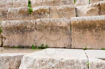 ancient greek numbers on stone seats in antique Large South Theatre, Jerash in Jordan