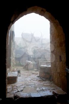 entrance in medieval Ajlun Castle in foggy day, Jordan