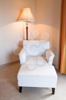 white leather chair and stand lamp in room corner