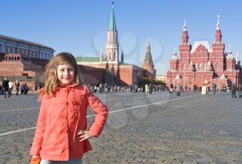 girl in red coat on Red Square in Moscow, Russia