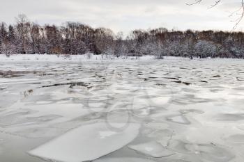 floating of ice on river at early spring evening