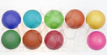 multicolored hen's eggs in holder