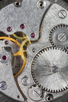 watch gears of old mechanic clockwork close up