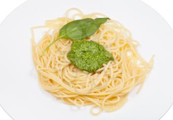 spaghetti with pesto and basil leaf on plate isolated on white background