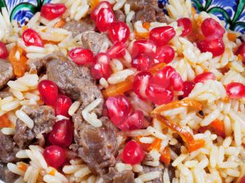background from asian pilau with pomegranate seeds and meat close up