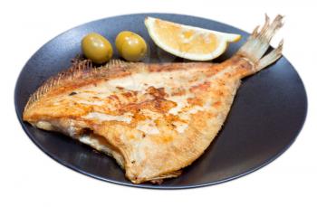 fried sole fish on black plate isolated on white background