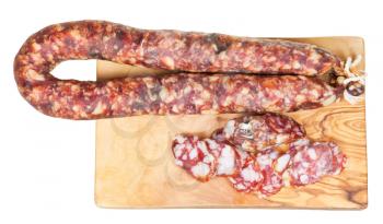 above view of dried smoked sausage on cutting wooden board isolated on white background