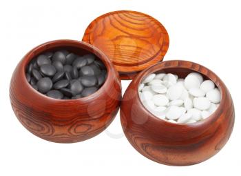 set of black and white go game stones in wooden bowls isolated on white background