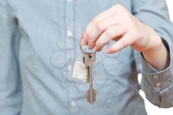 bunch of keys with fob in hand close up isolated on white background