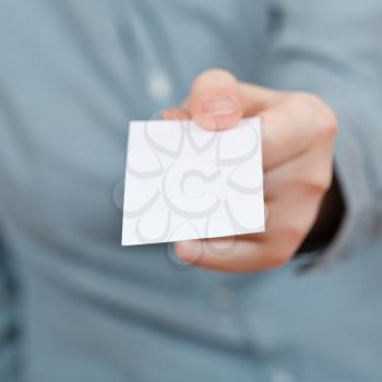 blank business card in female hand close up