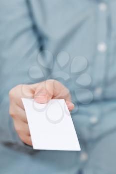 front view of blank business card in female hand close up