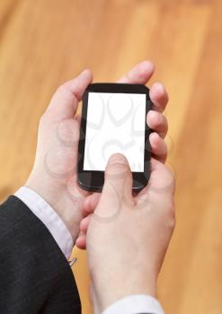 mobile phone with cut out screen in businessman hands close up