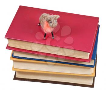top view of felt soft toy sheep on books isolated on white background