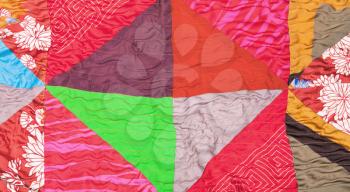 geometric pattern of silk patchwork quilt close up