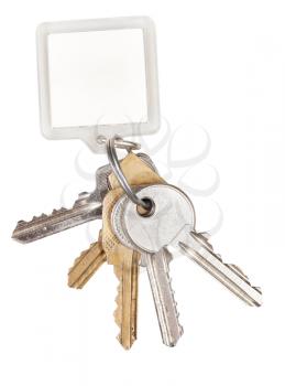 bunch of door keys on ring and keychain isolated on white background