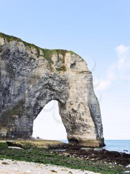 rock with arch on english channel beach of Etretat cote d'albatre, France
