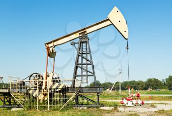 oil extraction by pumpjack in Caucasus region in summer day