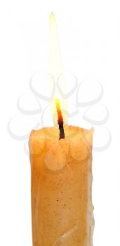 lighted yellow candle close up isolated on white background