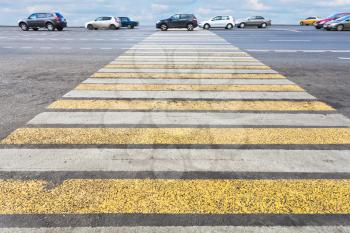 yellow and white pedestrian crossing on road