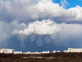 snow clouds over city in spring day