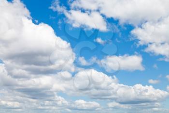 many woolpack clouds in blue sky in summer day
