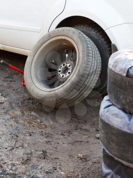 seasonal replacement of car tyres outdoors - car tire fitting