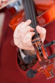 girl playing violin - chord on fingerboard close up