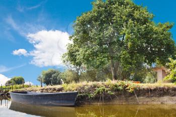 wooden boat in lake in village de Breca, in Briere Regional Natural Park, France