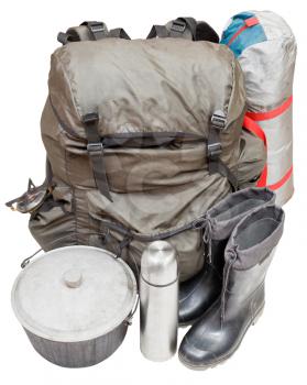 set of expedition equipment with backpack, tent, pot, rubber boots, thermos, gas burner isolated on white background