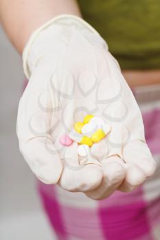 several tablets in gloved hand close up