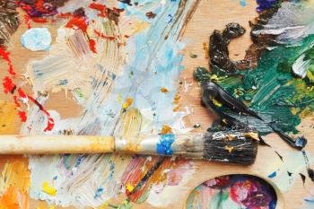 paint brush on wooden used artistic palette