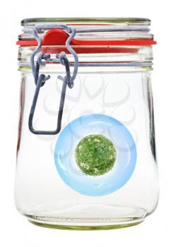 little green rural planet preserved in closed glass jar